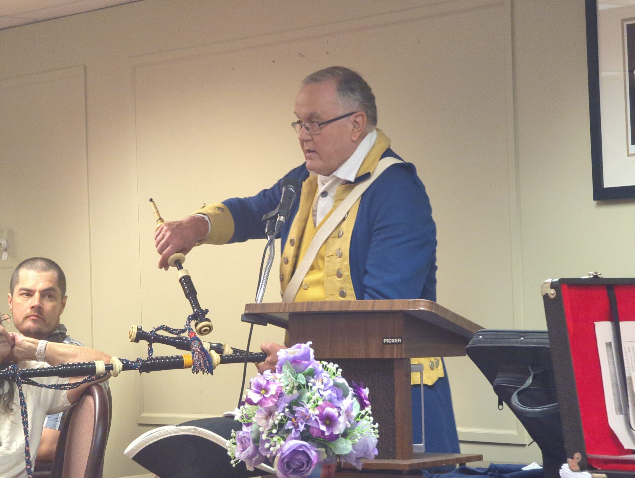 Compatriot Ron Barnard discussing bagpipes